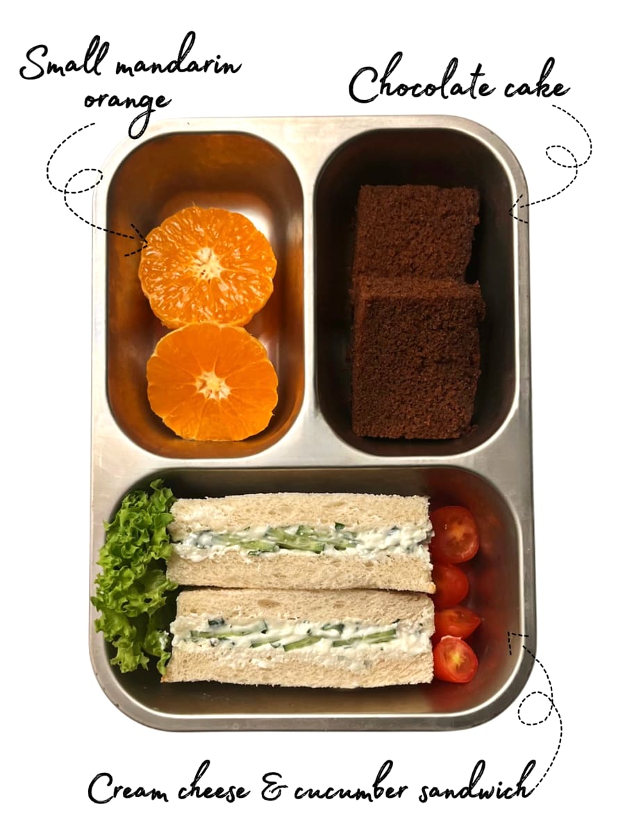 Lunchbox: Cream cheese and cucumber sandwich with mandarin and chocolate cake